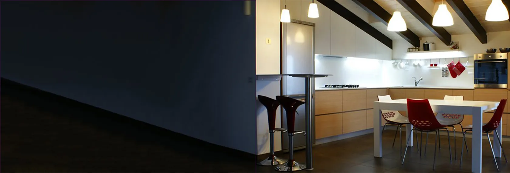 Cuisine moderne avec îlot central, bar, table et éclairage suspendu.